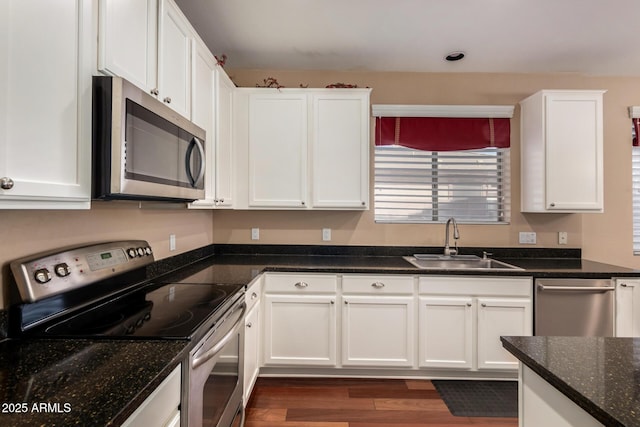3065 E Harvard Ave, Gilbert, AZ 85234 - kitchen with stainless steel appliances, a sink, white cabinets, dark wood finished floors, and dark stone counters