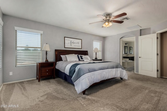 3065 E Harvard Ave, Gilbert, AZ 85234 - bedroom featuring carpet floors, arched walkways, baseboards, ensuite bathroom, and ceiling fan
