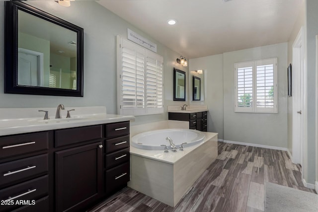 3065 E Harvard Ave, Gilbert, AZ 85234 - bathroom featuring wood finished floors, a bath, and two vanities