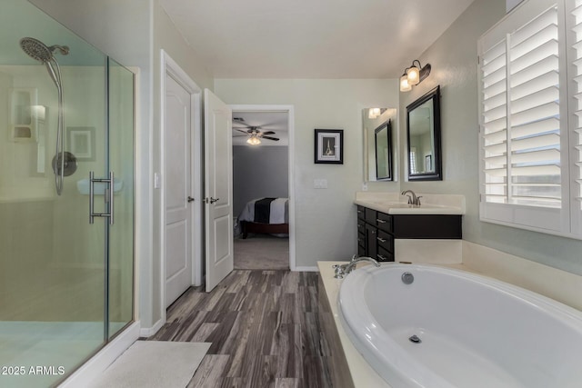 3065 E Harvard Ave, Gilbert, AZ 85234 - ensuite bathroom featuring a stall shower, a bath, wood finished floors, and a ceiling fan