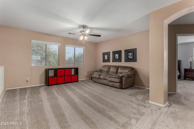 3065 E Harvard Ave, Gilbert, AZ 85234 - living room featuring arched walkways, carpet flooring, ceiling fan, and baseboards