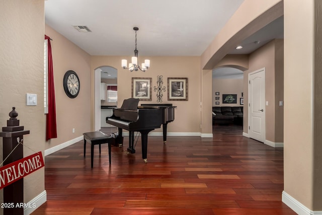 3065 E Harvard Ave, Gilbert, AZ 85234 - living area featuring arched walkways, wood finished floors, a chandelier, and baseboards