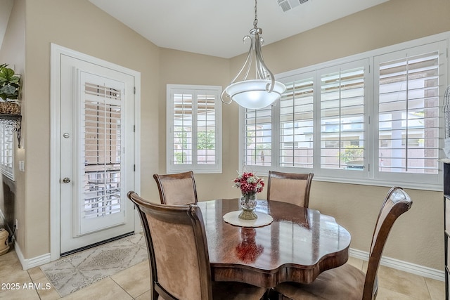 dining space featuring light tile patterned floors