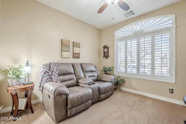 living room with ceiling fan and light colored carpet