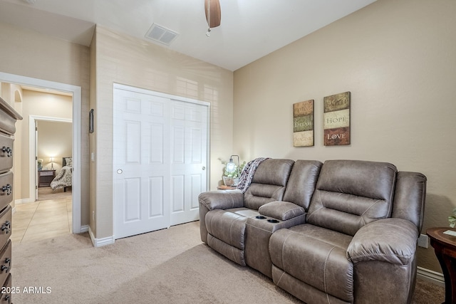 living room with light carpet and ceiling fan