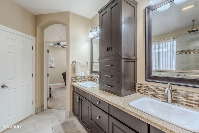 bathroom featuring decorative backsplash, vanity, ceiling fan, walk in shower, and tile patterned floors