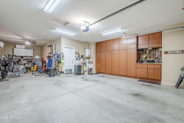 garage with a garage door opener, a wall mounted air conditioner, and water heater