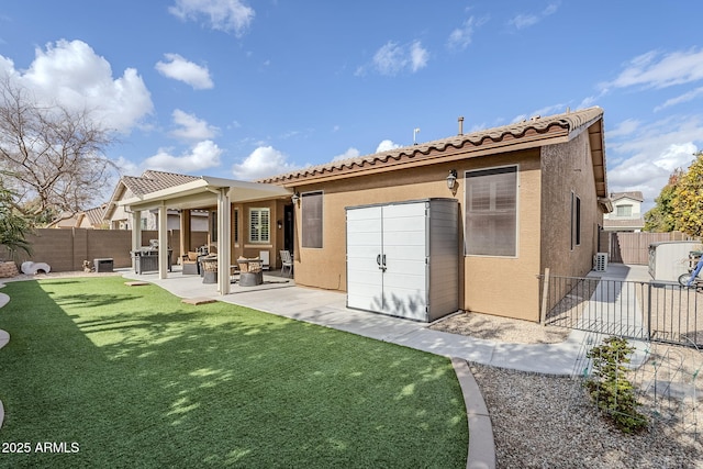 rear view of property featuring a yard and a patio