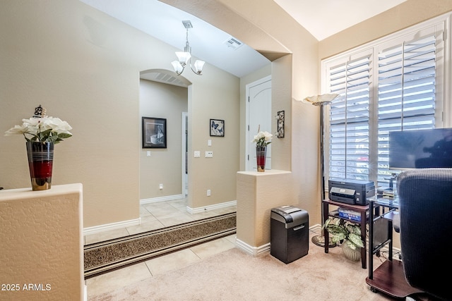 interior space with an inviting chandelier, lofted ceiling, and tile patterned floors