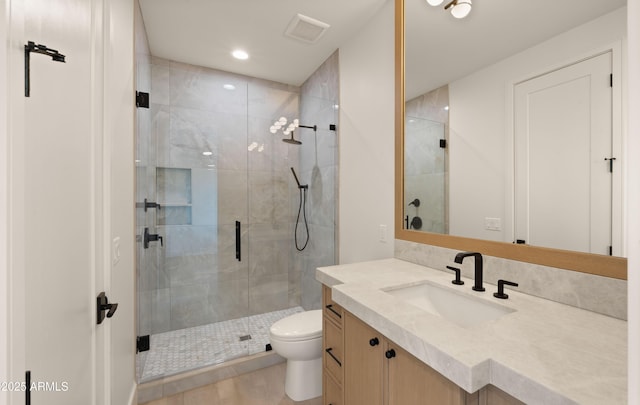 4911 E Amelia Ave, Phoenix, AZ 85018 - bathroom with vanity, a shower stall, toilet, and recessed lighting