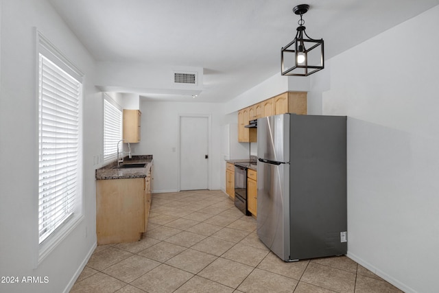 kitchen with black range with electric stovetop, light brown cabinets, sink, stainless steel fridge, and decorative light fixtures