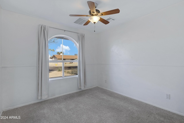 unfurnished room with ceiling fan and carpet