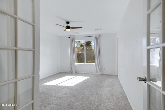 spare room featuring carpet flooring and ceiling fan