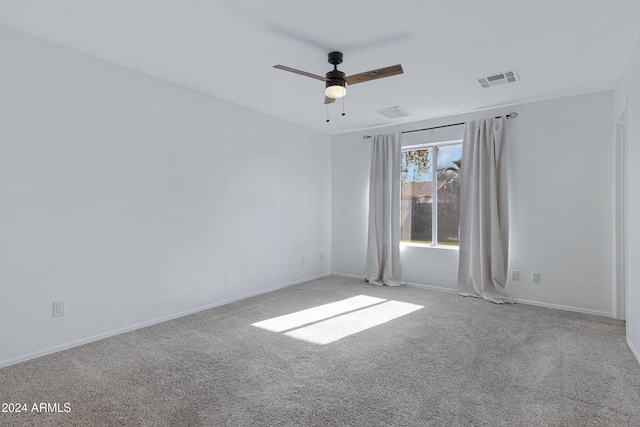 carpeted spare room with ceiling fan