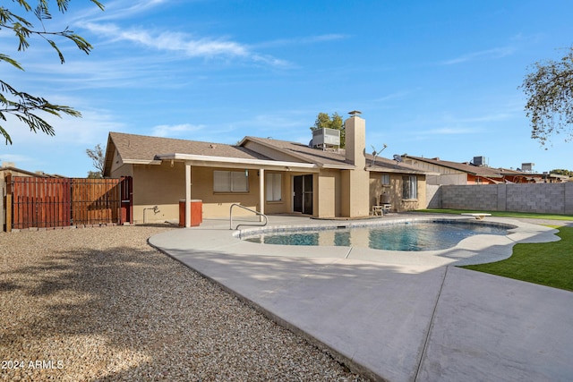 back of house with a patio, a fenced in pool, and cooling unit