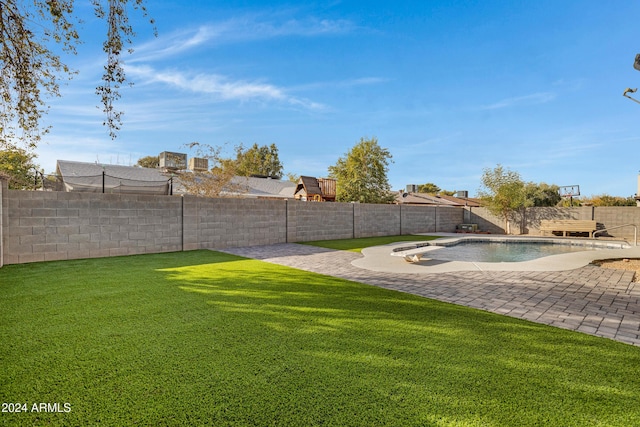 view of yard with a fenced in pool and a patio area