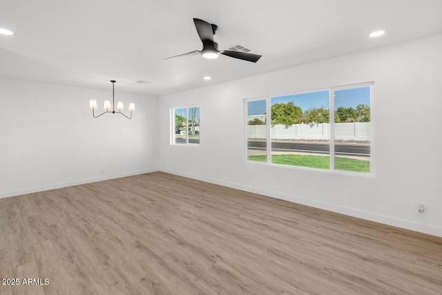 6610 N 15th Ave, Phoenix, AZ 85015 - spare room with ceiling fan with notable chandelier, light wood-style floors, baseboards, visible vents, and recessed lighting