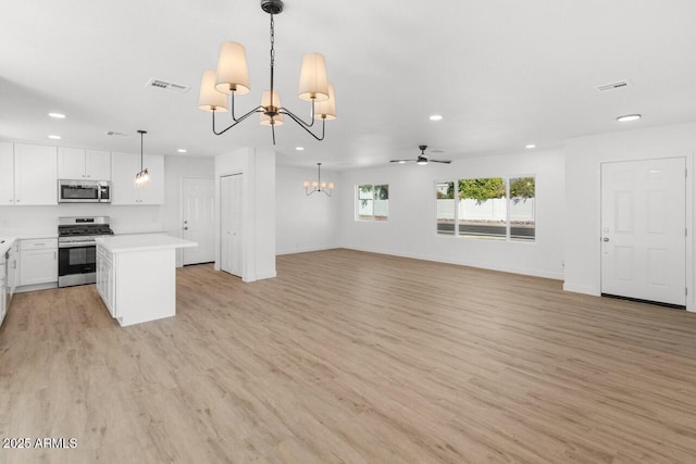 6610 N 15th Ave, Phoenix, AZ 85015 - kitchen with recessed lighting, white cabinets, light countertops, appliances with stainless steel finishes, and open floor plan