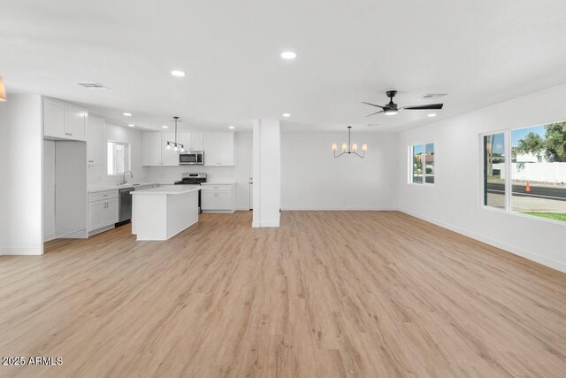 6610 N 15th Ave, Phoenix, AZ 85015 - unfurnished living room featuring recessed lighting, visible vents, a sink, light wood-style floors, and baseboards