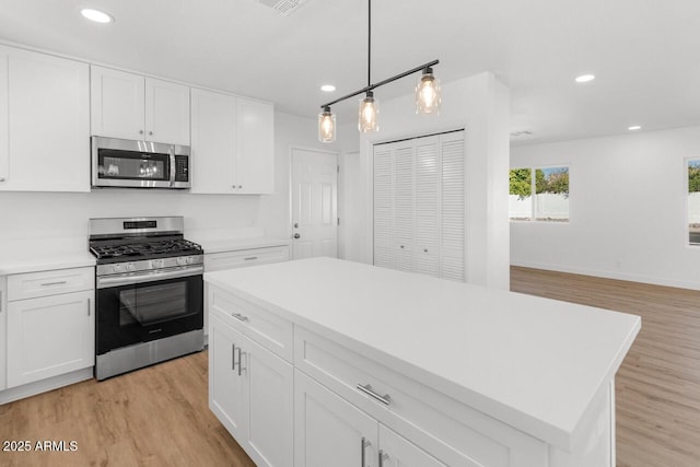 6610 N 15th Ave, Phoenix, AZ 85015 - kitchen featuring white cabinets, recessed lighting, appliances with stainless steel finishes, and light wood-style flooring