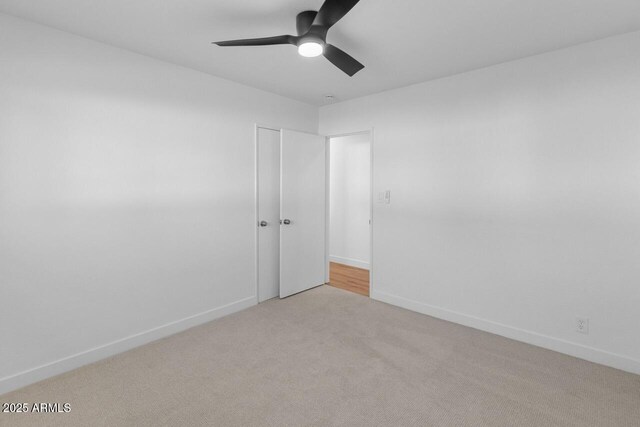 6610 N 15th Ave, Phoenix, AZ 85015 - empty room with carpet floors, a ceiling fan, and baseboards