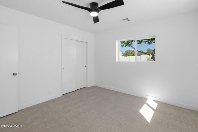 6610 N 15th Ave, Phoenix, AZ 85015 - unfurnished bedroom with carpet flooring, visible vents, baseboards, a ceiling fan, and a closet