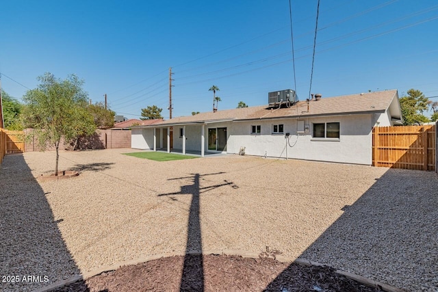 6610 N 15th Ave, Phoenix, AZ 85015 - back of property with stucco siding, a patio, a fenced backyard, and central AC unit