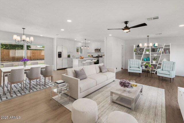 6610 N 15th Ave, Phoenix, AZ 85015 - living area featuring ceiling fan with notable chandelier, light wood-style flooring, visible vents, and recessed lighting