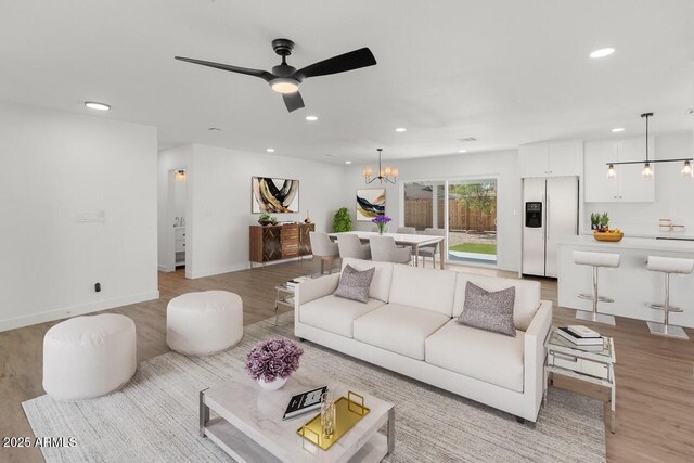 6610 N 15th Ave, Phoenix, AZ 85015 - living room with ceiling fan with notable chandelier, light wood-style flooring, baseboards, and recessed lighting