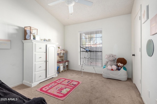 interior space featuring lofted ceiling, a textured ceiling, ceiling fan, and light carpet