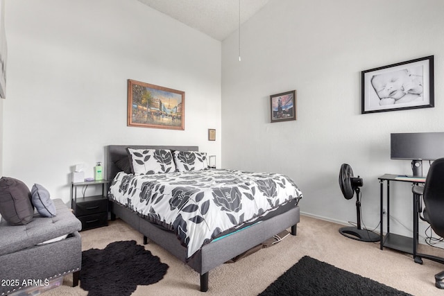 carpeted bedroom featuring high vaulted ceiling