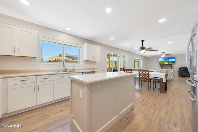 5744 E Jacaranda St, Mesa, AZ 85205 - kitchen featuring a center island, healthy amount of natural light, recessed lighting, tasteful backsplash, and light wood-type flooring