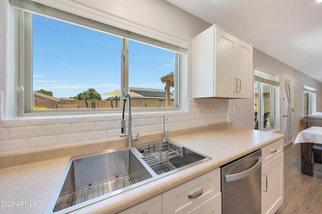5744 E Jacaranda St, Mesa, AZ 85205 - kitchen with stainless steel dishwasher, white cabinets, tasteful backsplash, and light countertops