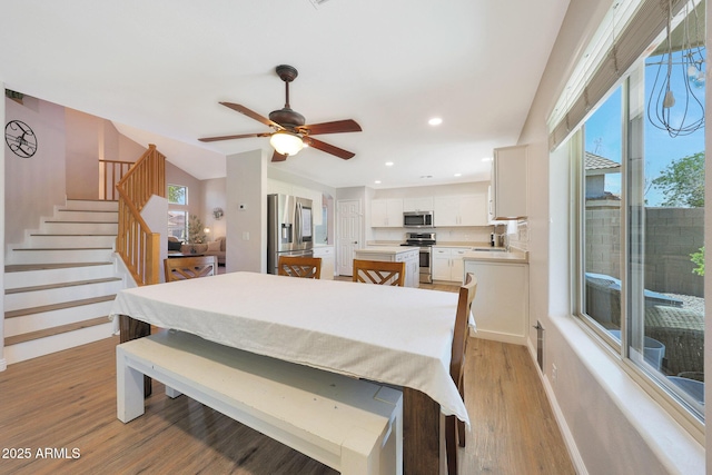 5744 E Jacaranda St, Mesa, AZ 85205 - dining area featuring light wood-style flooring, ceiling fan, stairs, and recessed lighting
