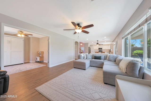 5744 E Jacaranda St, Mesa, AZ 85205 - living area featuring a ceiling fan, light wood-style flooring, arched walkways, and recessed lighting
