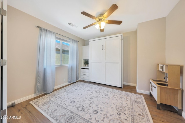 5744 E Jacaranda St, Mesa, AZ 85205 - unfurnished bedroom with wood finished floors and ceiling fan