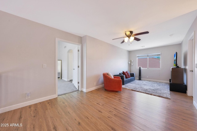 5744 E Jacaranda St, Mesa, AZ 85205 - living area featuring wood finished floors, ceiling fan, and arched walkways