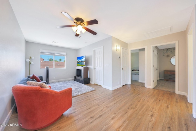 5744 E Jacaranda St, Mesa, AZ 85205 - living room featuring a ceiling fan and light wood-style floors