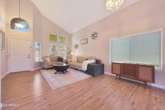 5744 E Jacaranda St, Mesa, AZ 85205 - living area featuring high vaulted ceiling, light wood-type flooring, and a chandelier