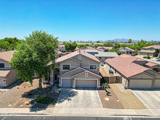 5744 E Jacaranda St, Mesa, AZ 85205 - view of front of house with concrete driveway, an attached garage, and a residential view