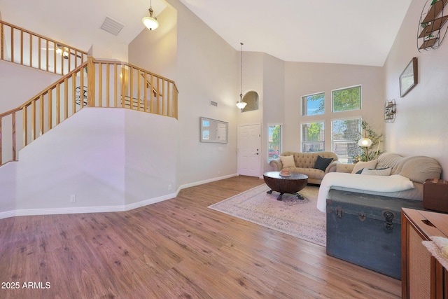 5744 E Jacaranda St, Mesa, AZ 85205 - living area featuring wood finished floors, high vaulted ceiling, and stairs