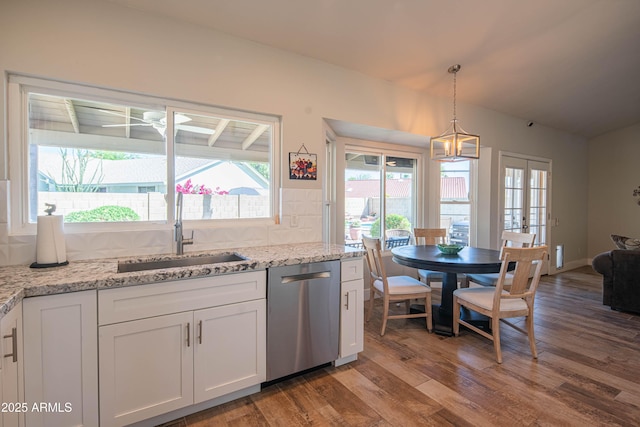 kitchen featuring white cabinets, a wealth of natural light, a sink, wood finished floors, and dishwasher