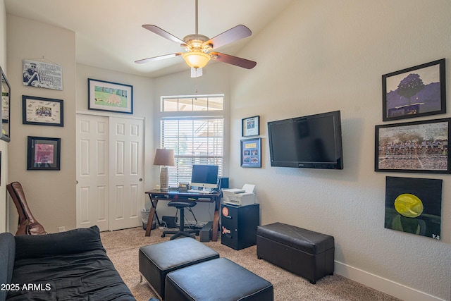carpeted home office featuring baseboards and a ceiling fan