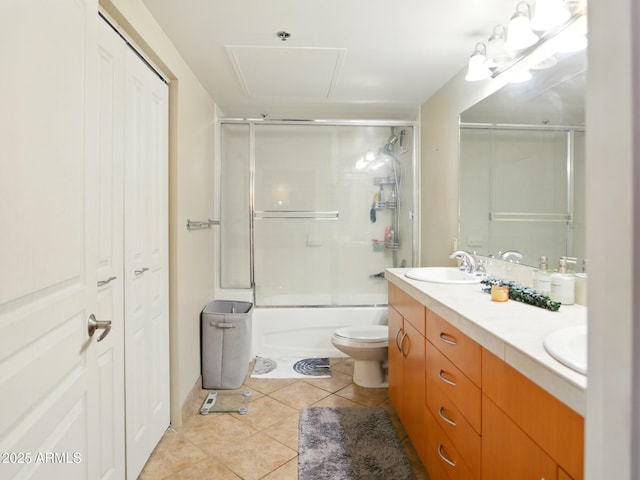 114 W Adams St Unit 505, Phoenix, AZ 85003 - bathroom with tile patterned floors, double vanity, bath / shower combo with glass door, and a closet