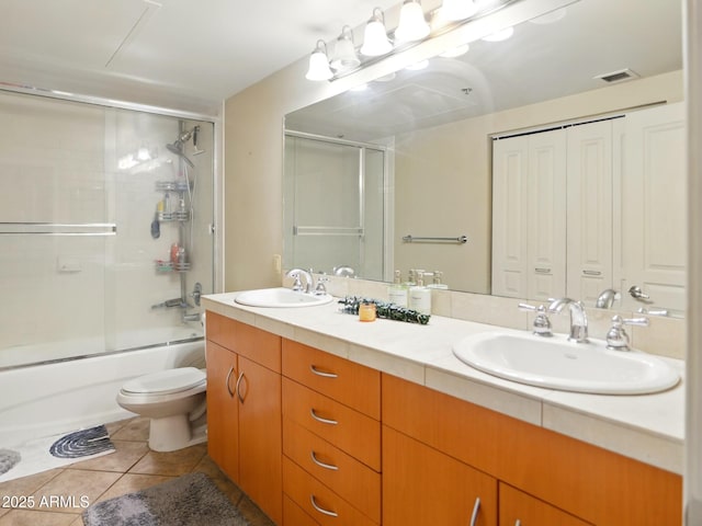 114 W Adams St Unit 505, Phoenix, AZ 85003 - bathroom featuring double vanity, bath / shower combo with glass door, and tile patterned flooring