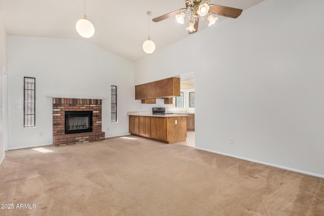 6602 W Ironwood Dr, Glendale, AZ 85302 - unfurnished living room featuring high vaulted ceiling, light colored carpet, a ceiling fan, baseboards, and a fireplace