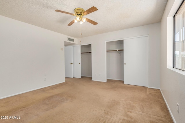 6602 W Ironwood Dr, Glendale, AZ 85302 - unfurnished bedroom featuring multiple closets, carpet floors, a textured ceiling, baseboards, and ceiling fan