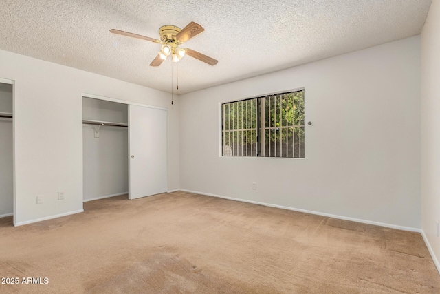 6602 W Ironwood Dr, Glendale, AZ 85302 - unfurnished bedroom with carpet flooring, a textured ceiling, multiple closets, baseboards, and a ceiling fan