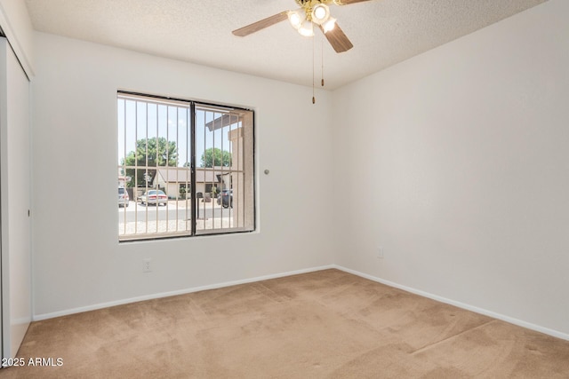 6602 W Ironwood Dr, Glendale, AZ 85302 - spare room with carpet, a ceiling fan, baseboards, and a textured ceiling