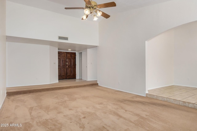 6602 W Ironwood Dr, Glendale, AZ 85302 - unfurnished living room featuring carpet flooring, a ceiling fan, high vaulted ceiling, and baseboards